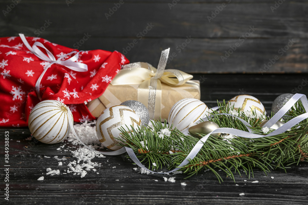 Santa bag with gifts and decor on wooden background