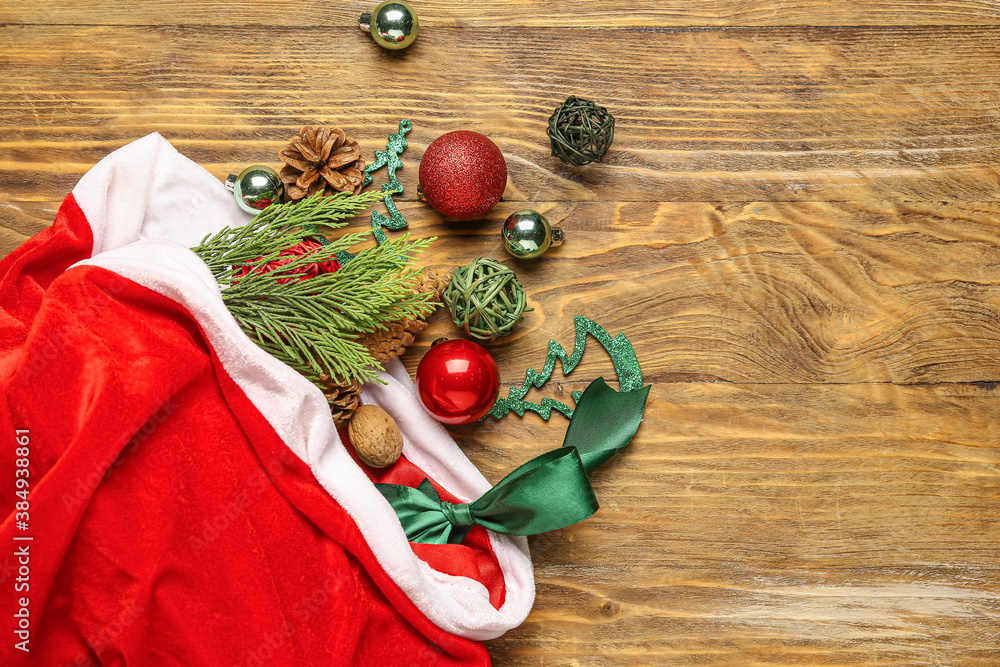 Santa bag with gifts and decor on wooden background