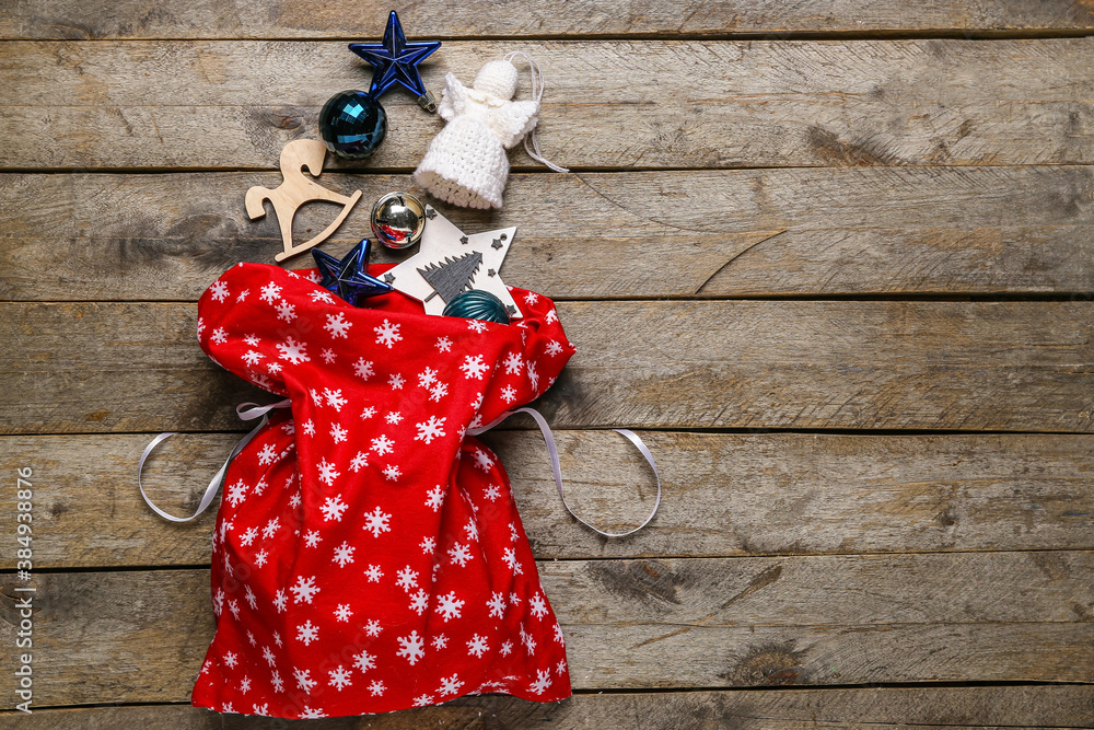 Santa bag with gifts on wooden background