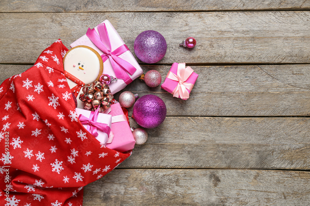 Santa bag with gifts on wooden background