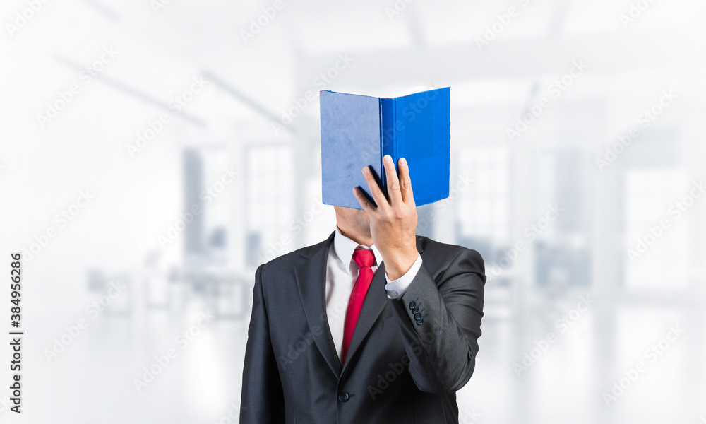 Businessman covered his face with book