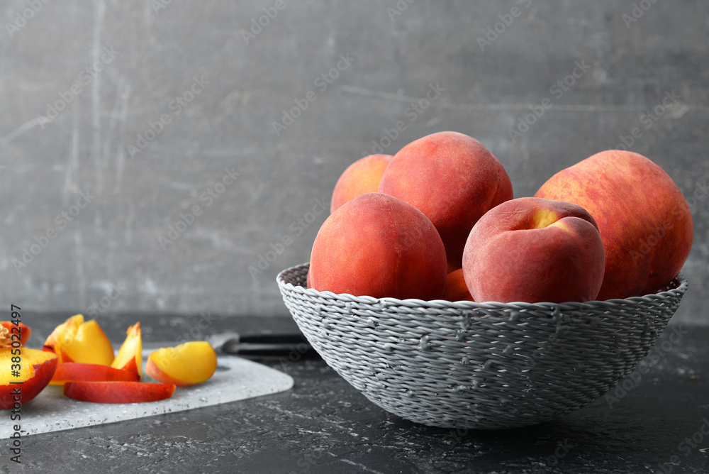 Sweet peaches in bowl on table