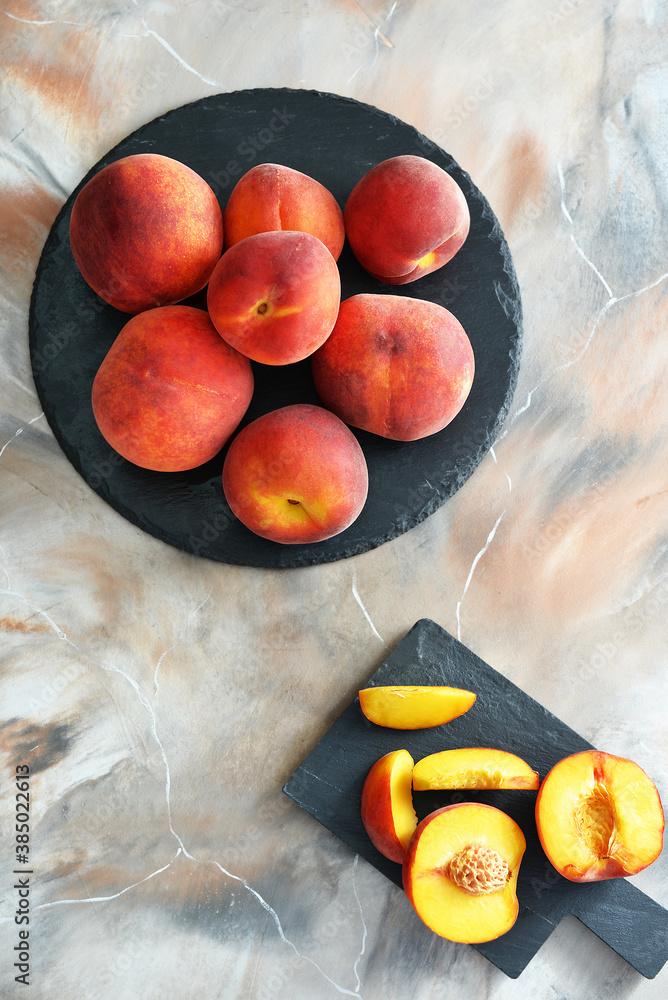 Sweet ripe peaches on color background