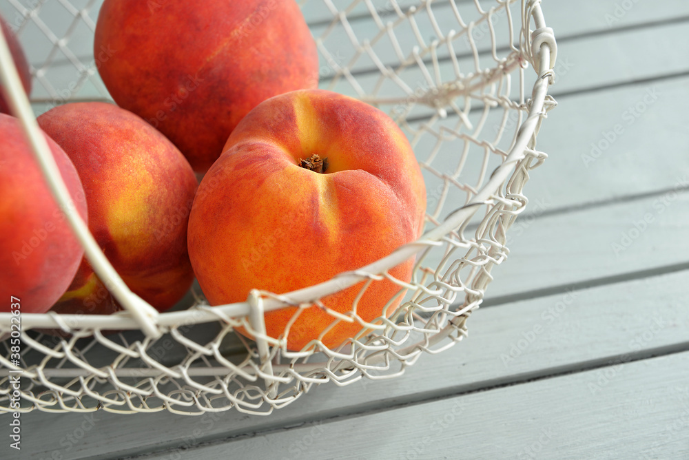 Sweet peaches in basket on table, closeup