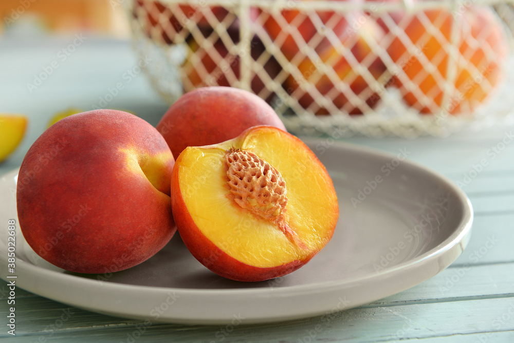 Plate with sweet peaches on table, closeup