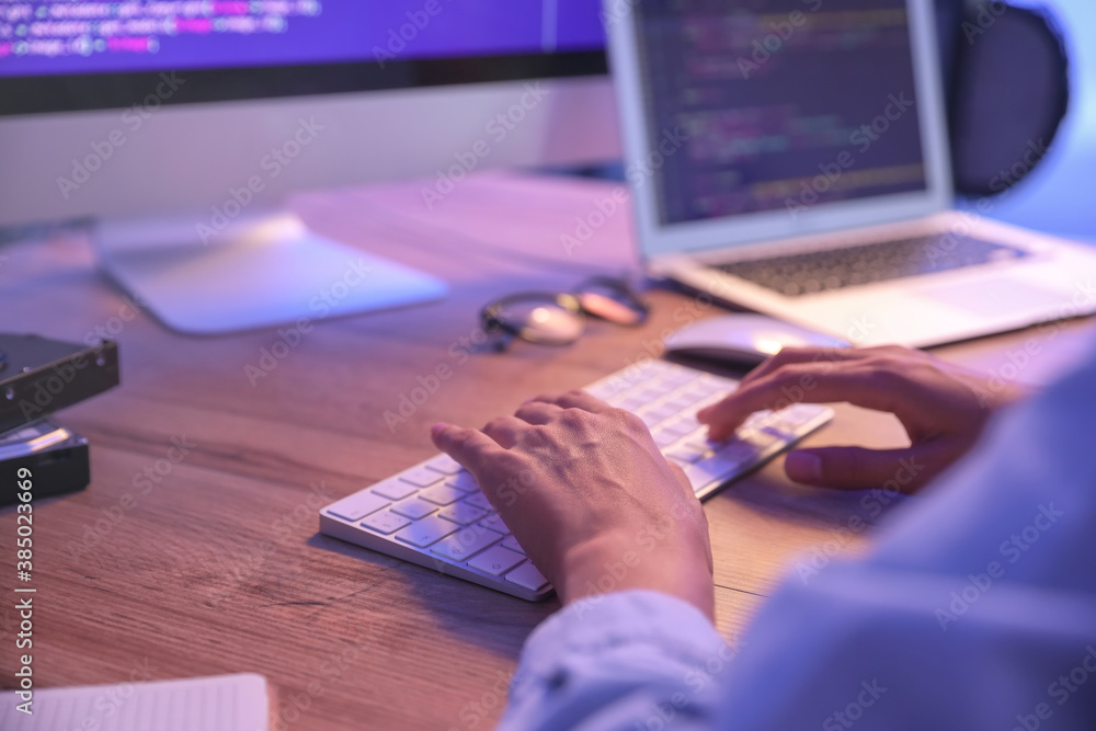 Female programmer working in office at night, closeup