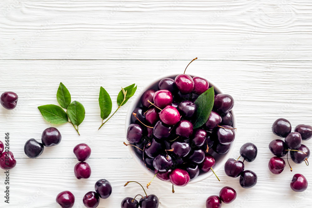 Berries in the bowl. Red cherry top view, copy space