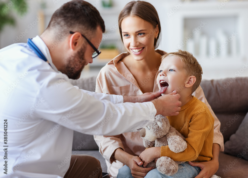 family doctor pediatrician conducts examination of   child boy with his mother, looks at his throat 