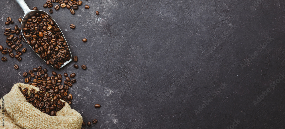 coffee beans in a sack on dark background, top view, copy space