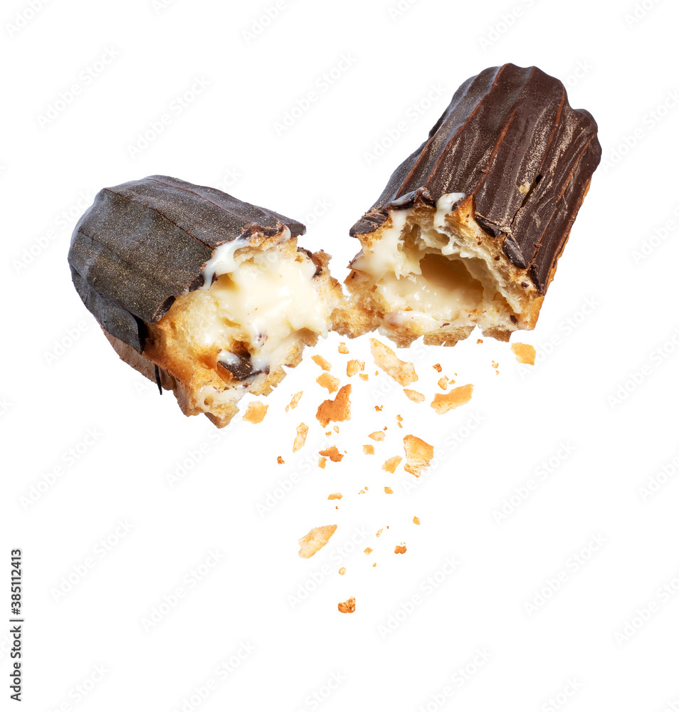 Delicious chocolate eclair broken into two halves in the air close-up