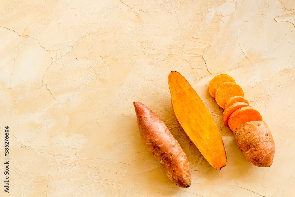 Layout of sweet potatoes. Organic vegetables background, overhead view