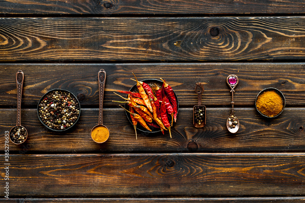 Spices and condiments in metal bowls and spoons. Overhead view