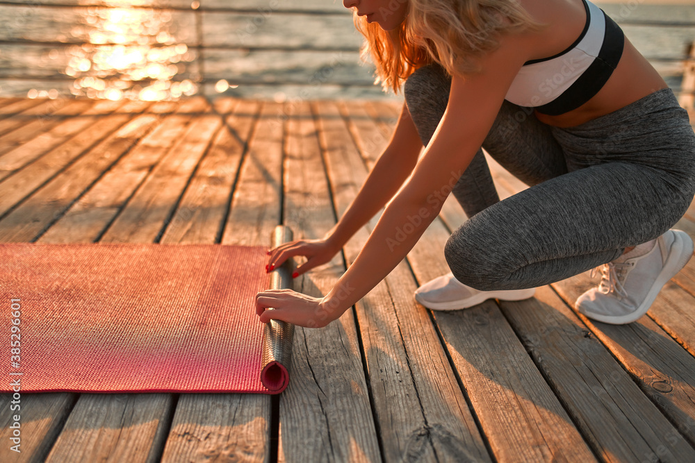 Girl doing yoga on sunrise