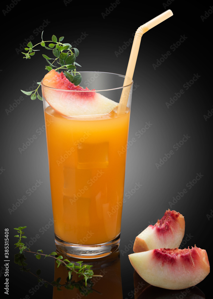 Summer cold drinks.Homemade peach cocktail with ice cubes in glass on black background