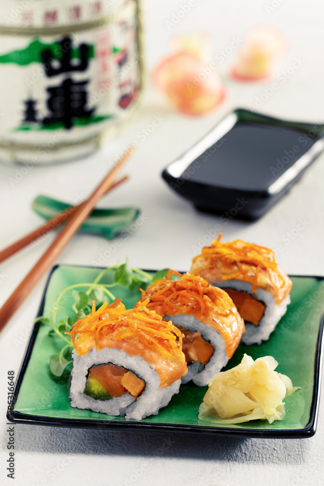 Sushi rolls set served on green plate on light background.Menu concept.