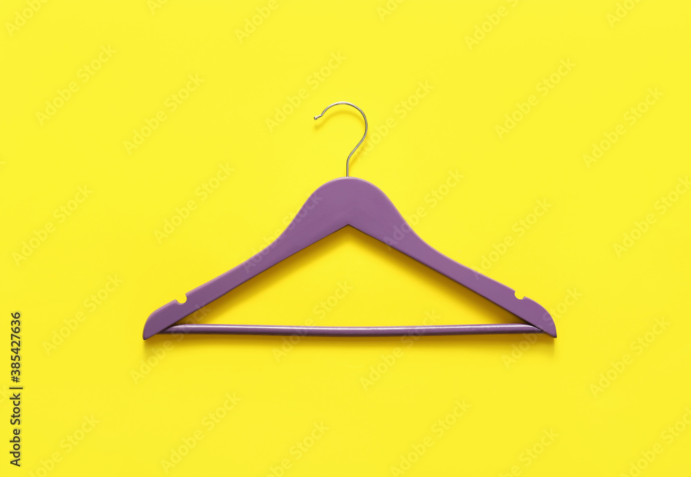 Clothes hanger on color background