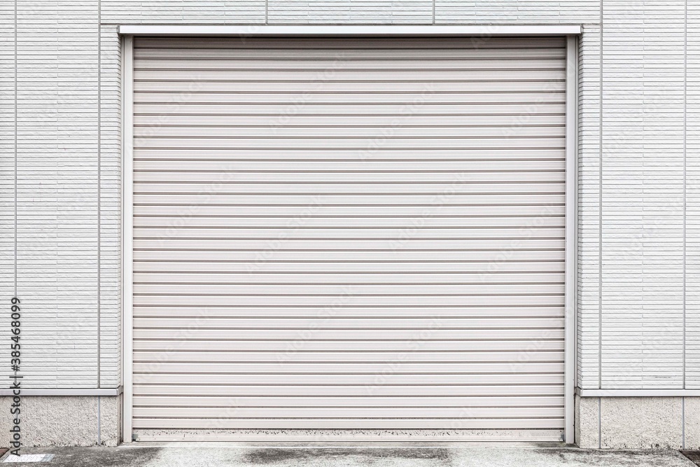 Automatic white roller shutter doors on the ground floor of the house