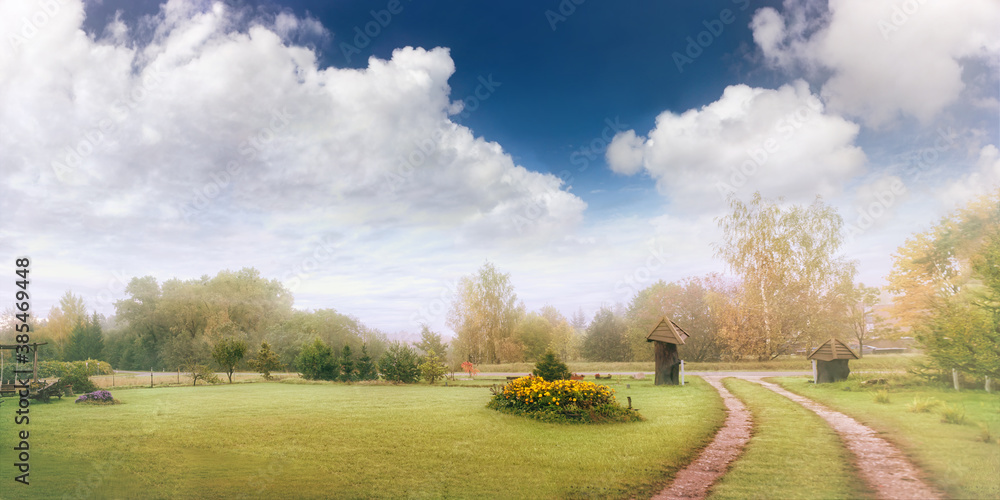 Panoramic autumn landscape with beautiful clouds in the foggy morning