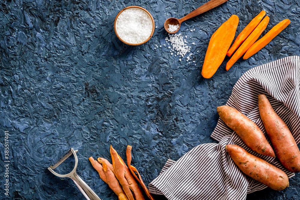 Overhead view of sweet potato sliced on kitchen board. Top view