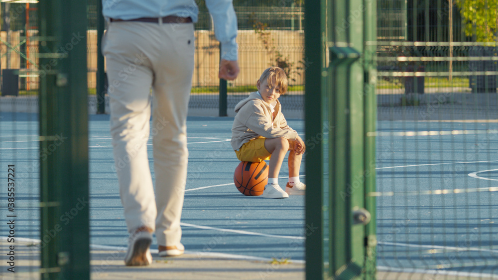 Man and child on the basketball court