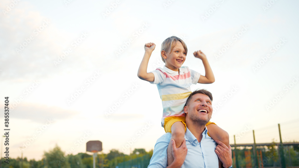 Happy father and son on the court