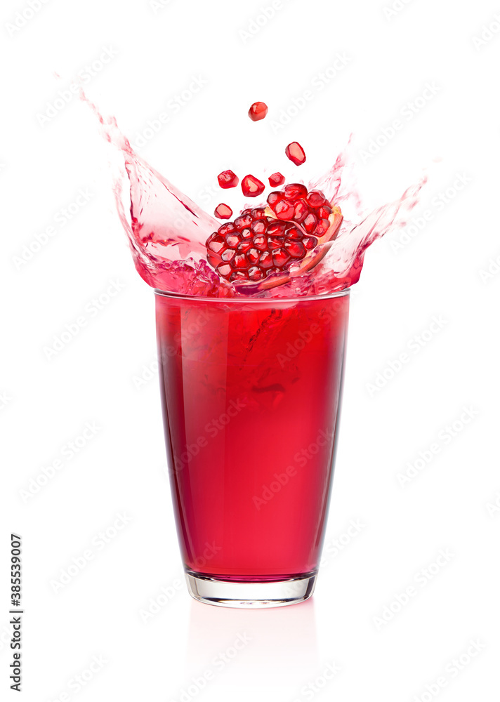 Glass of Pomegranate juice splashing  with Pomegranate fruit  isolated on white background.