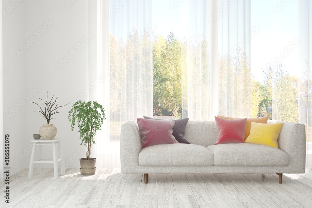 Stylish room in white color with sofa and autumn landscape in window. Scandinavian interior design. 