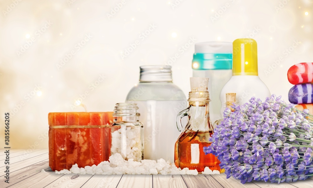 Pile of lavender flowers and a dropper bottle with lavender essence