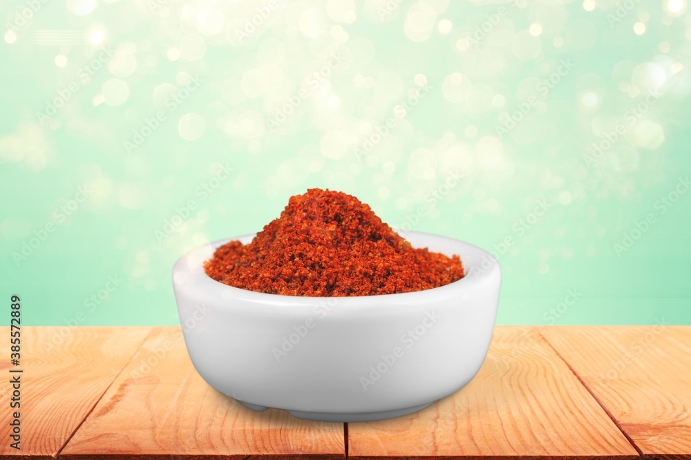 Paprika powder in a ceramic bowl on the desk