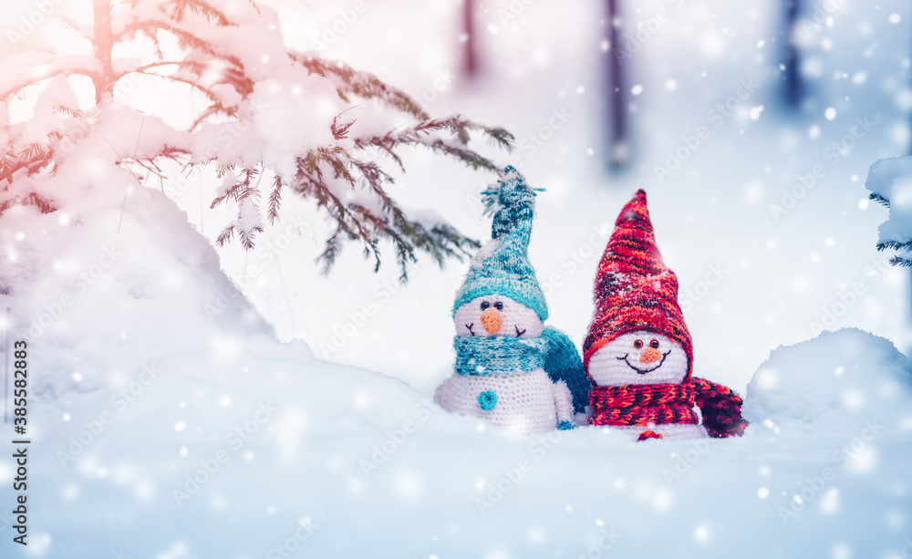 little snowmans on soft snow on blue background