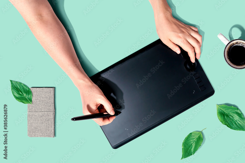 Person using a graphic pen tablet - flat lay