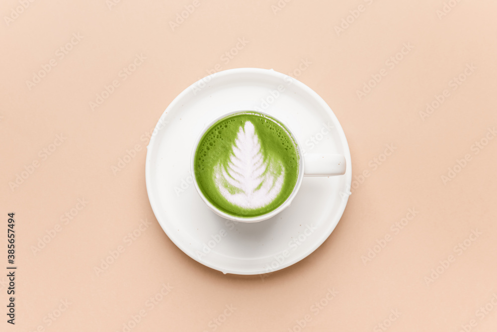 Cup of matcha tea on color background