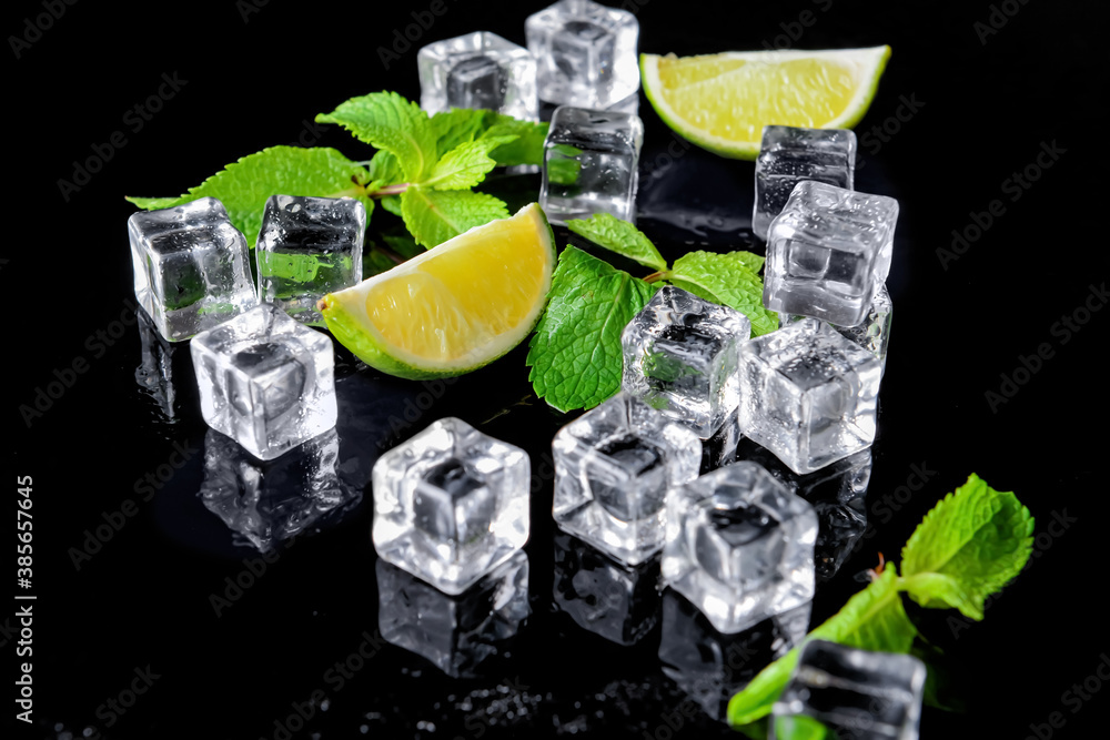 Ice cubes, lime and mint on dark background