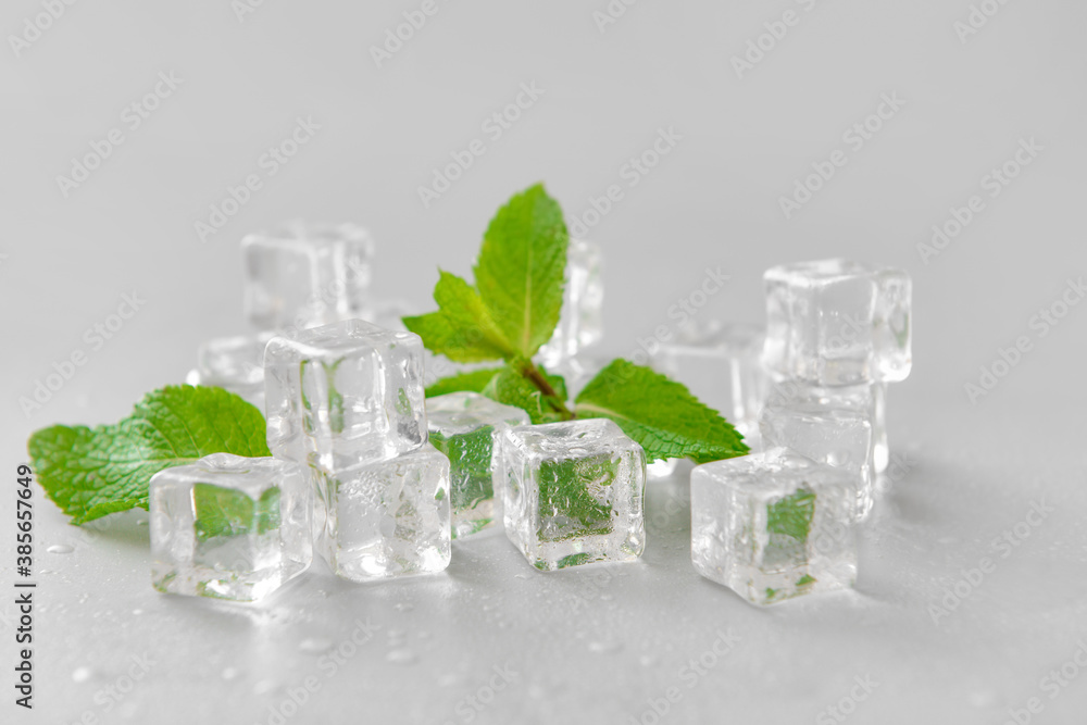 Ice cubes and mint on grey background