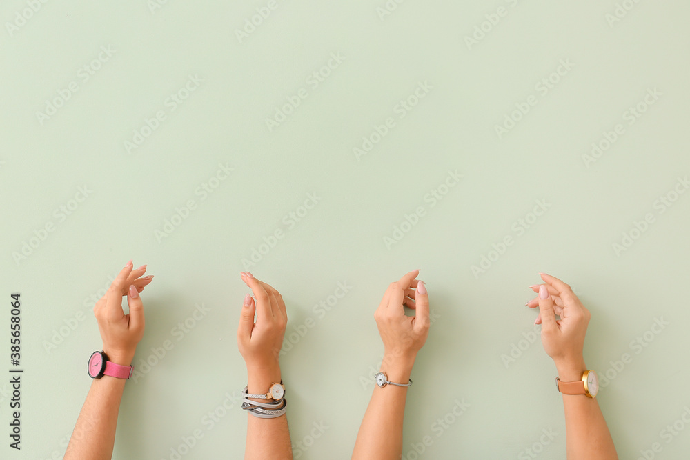 Female hands with watches on color background