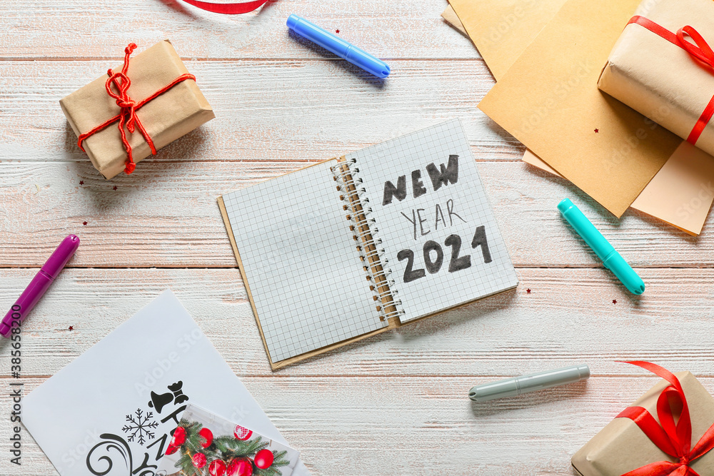 New Year composition with notebook on wooden background