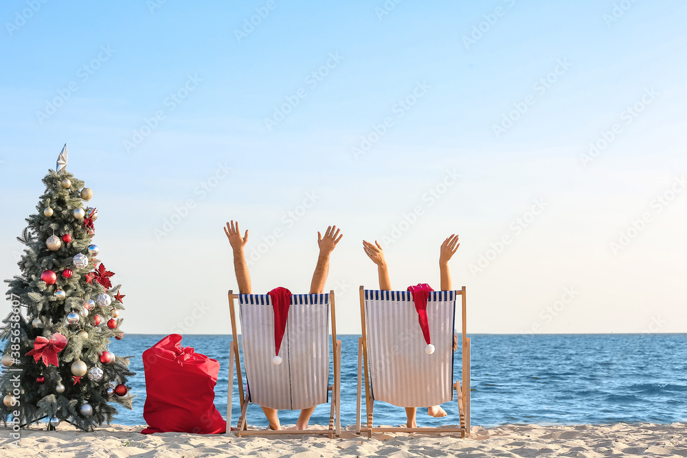 Happy couple celebrating Christmas at tropical resort