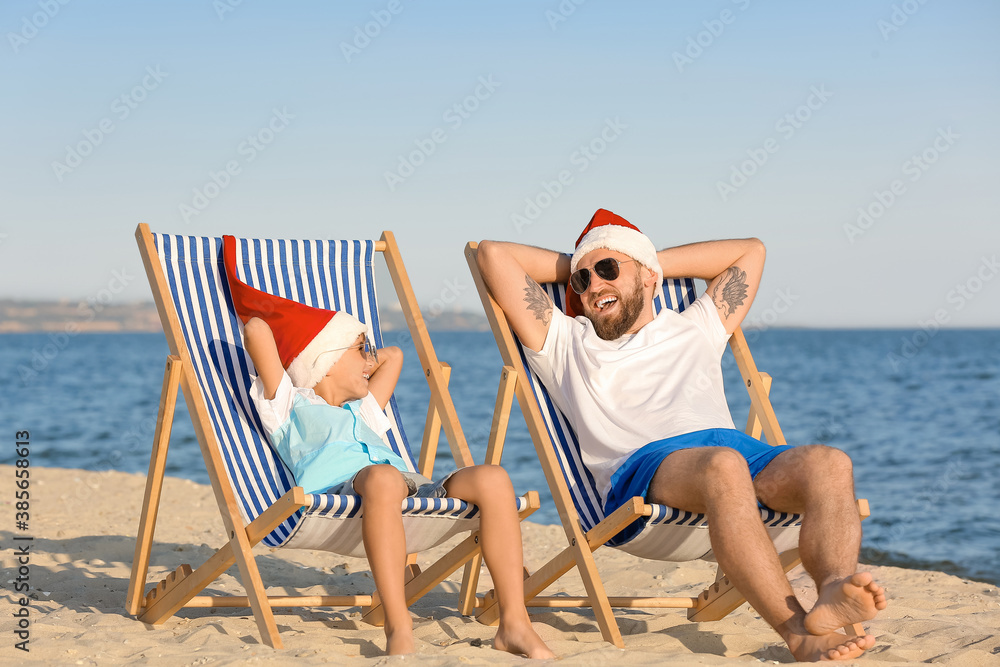 Happy man and his son celebrating Christmas at tropical resort