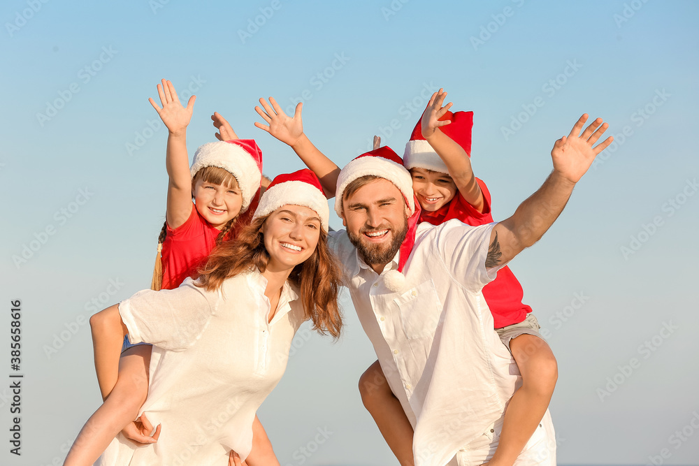 Happy family celebrating Christmas at tropical resort