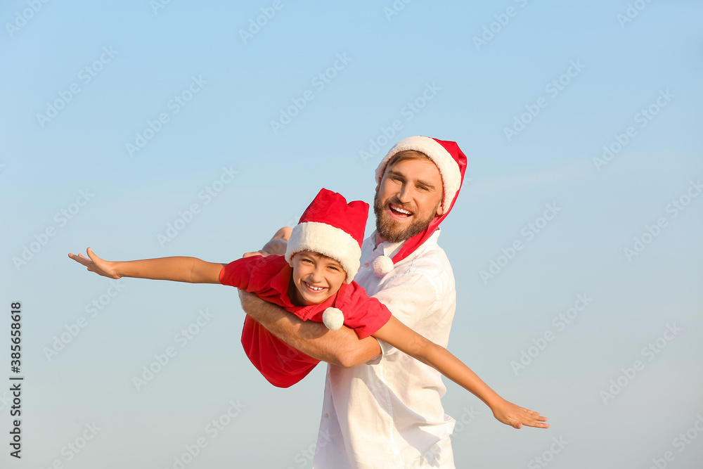 Happy man and his son celebrating Christmas at tropical resort