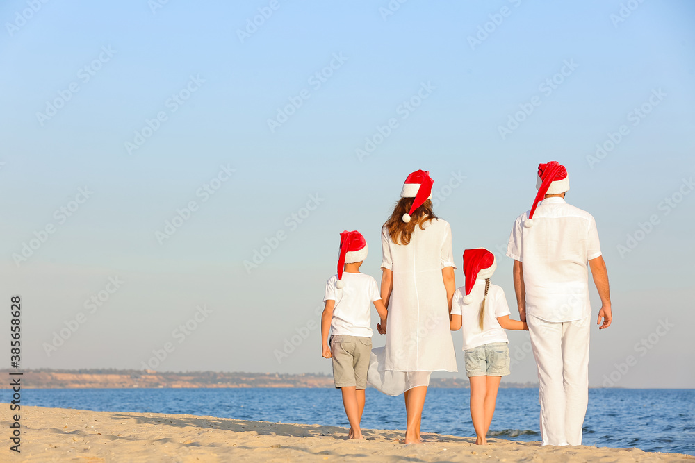 Happy family celebrating Christmas at tropical resort