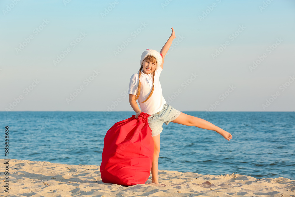 Happy little girl celebrating Christmas at tropical resort