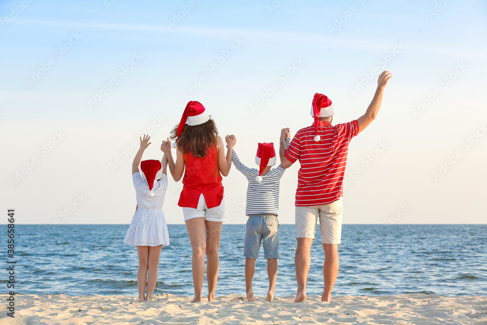 Happy family celebrating Christmas at tropical resort