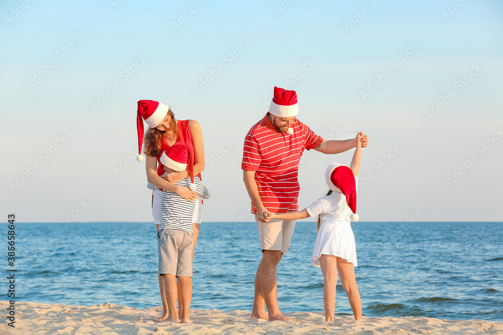 Happy family celebrating Christmas at tropical resort