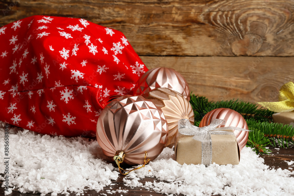 Santa bag with gifts and decor on wooden background