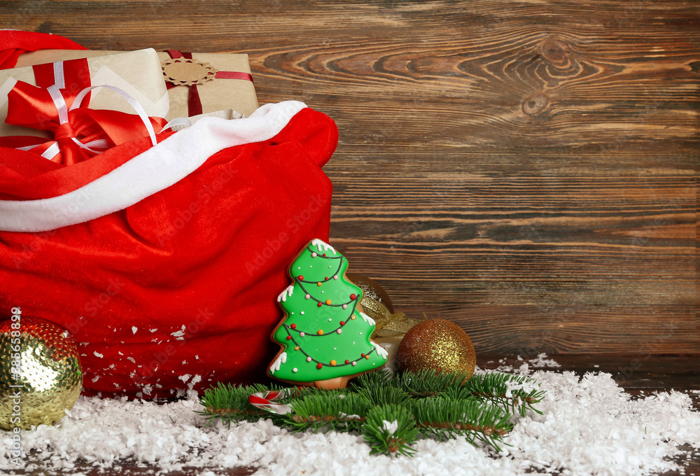 Santa bag with gifts and decor on wooden background