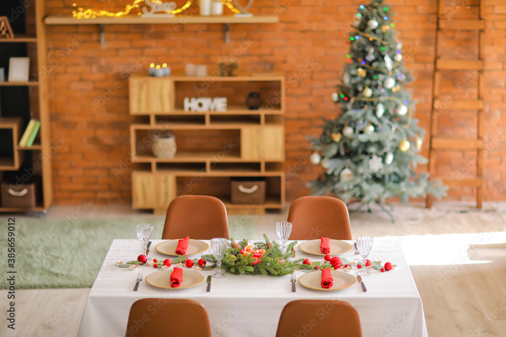 Interior of room with table set for Christmas dinner