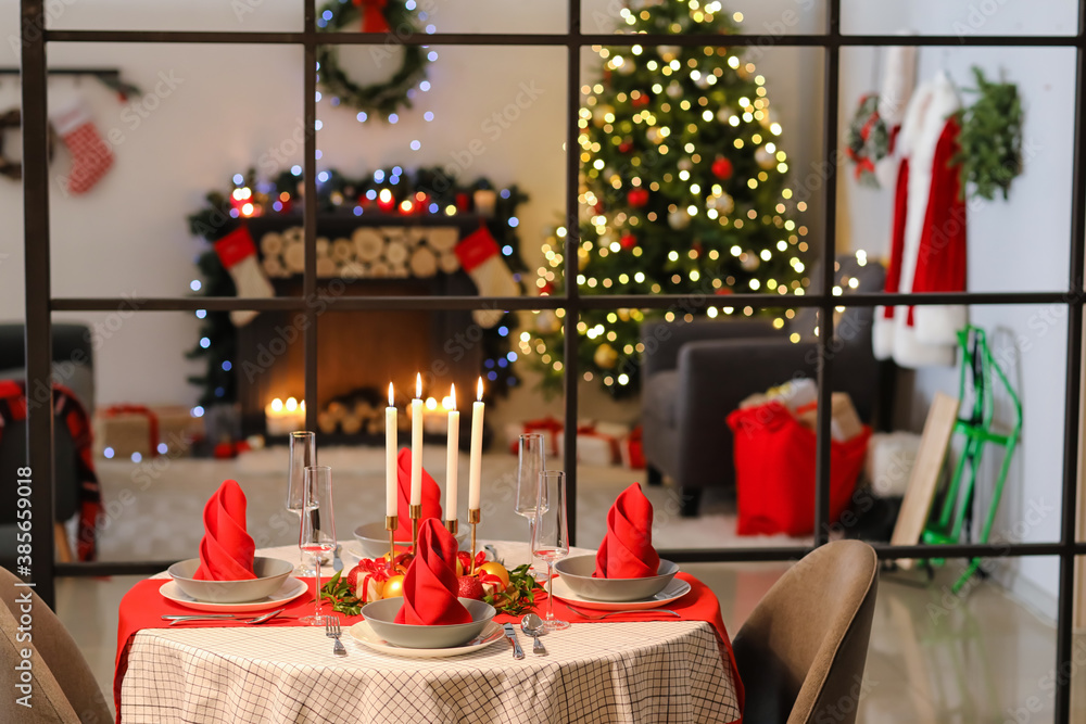 Interior of room with table set for Christmas dinner