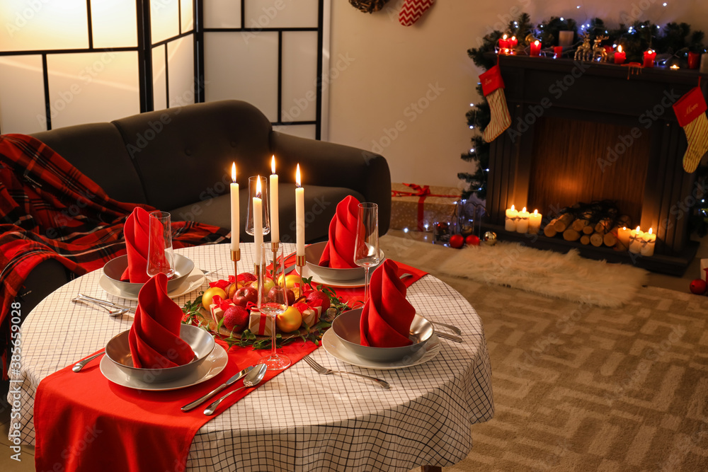 Interior of room with table set for Christmas dinner