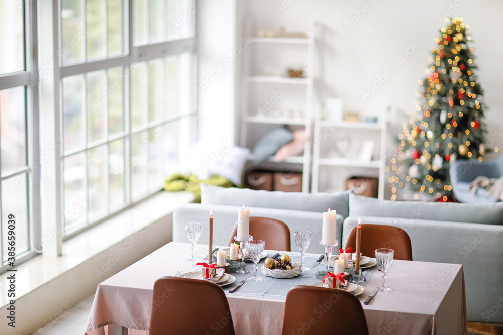 Interior of room with table set for Christmas dinner